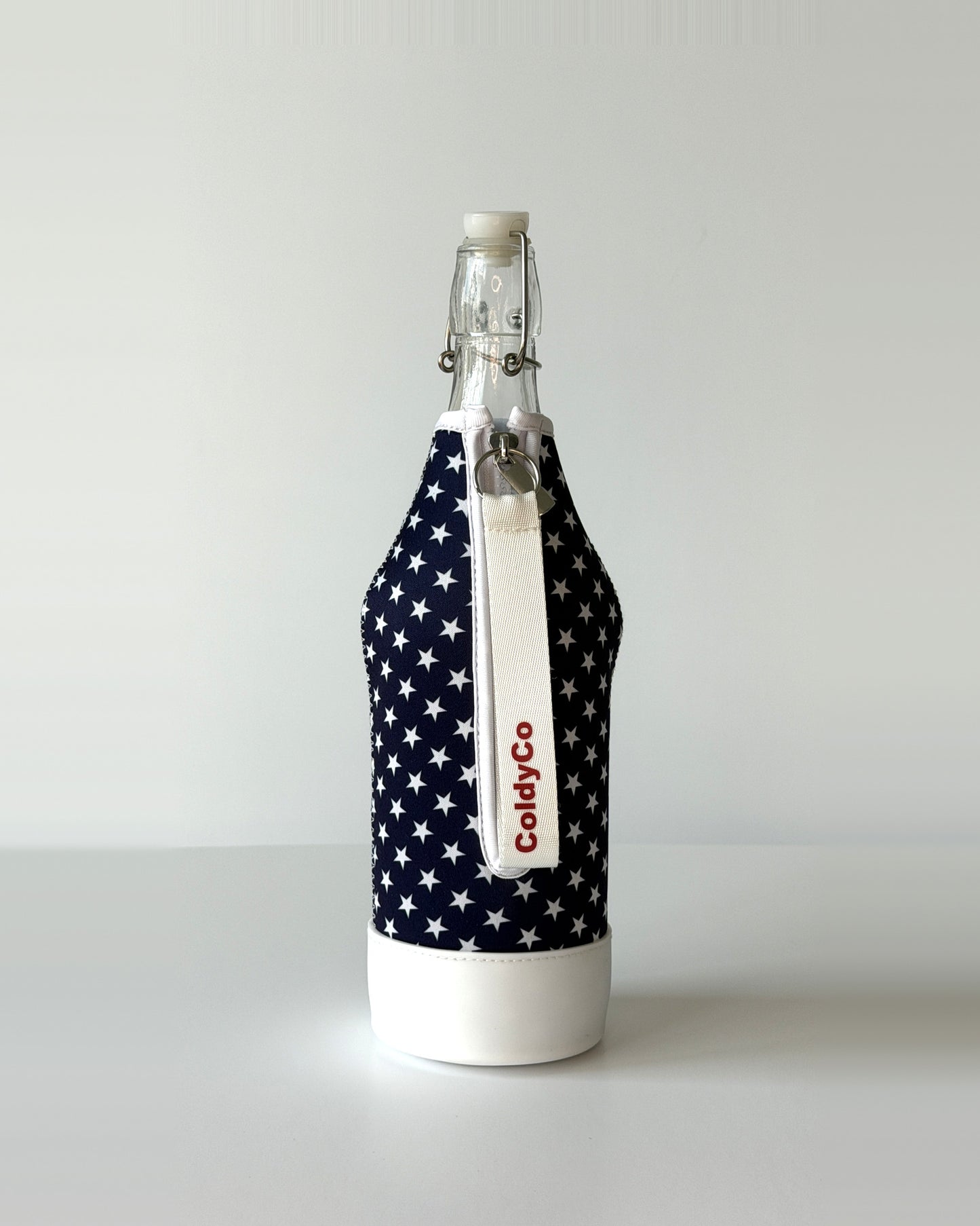 ColdyCo American Flag neoprene sleeve with wrist strap on a 1-liter glass bottle