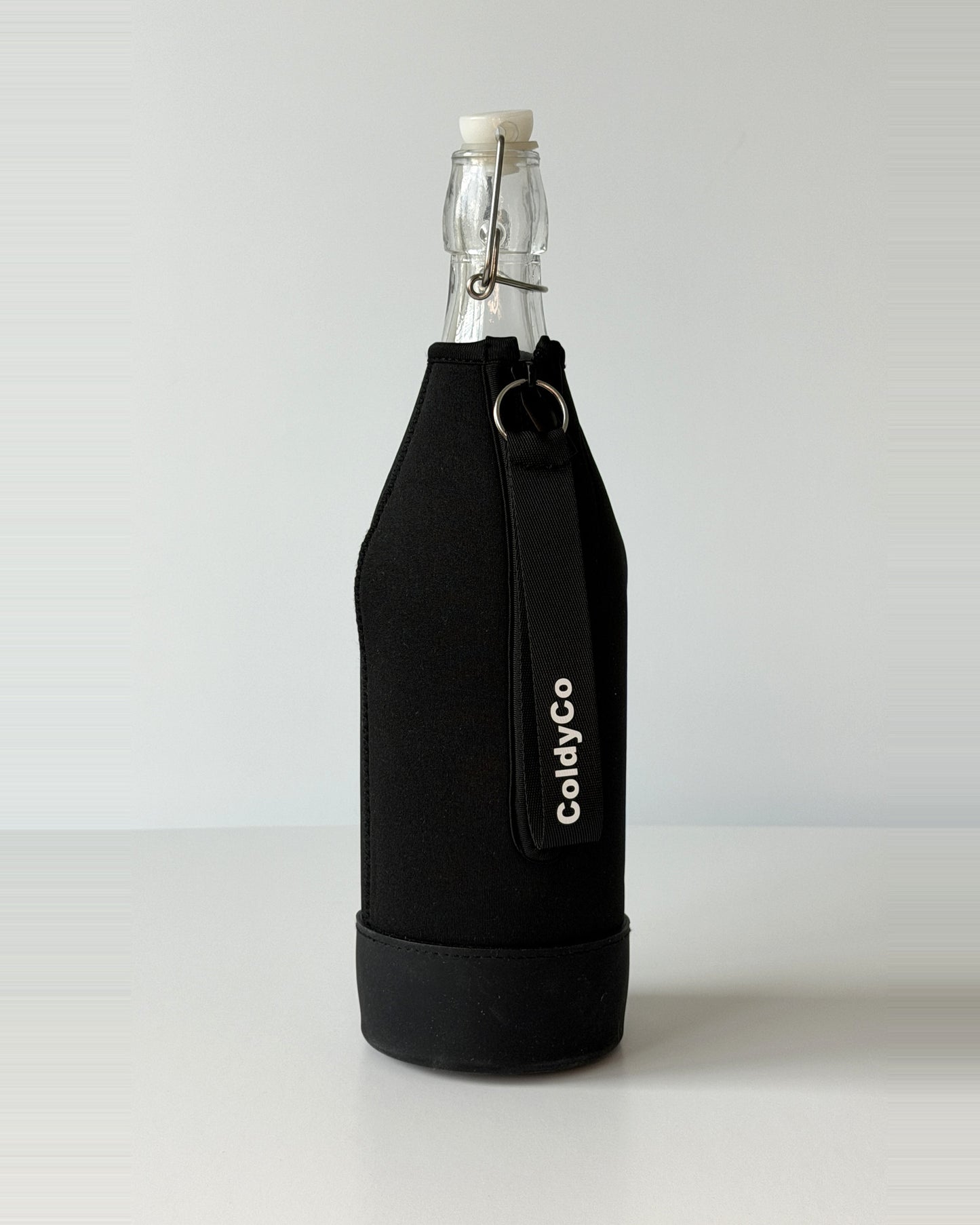 ColdyCo Black bottle carrier holding a swing-top glass bottle, side view