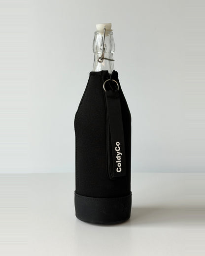 ColdyCo Black bottle carrier holding a swing-top glass bottle, side view