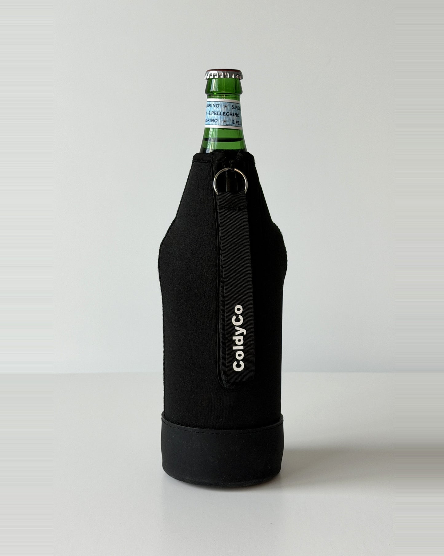 ColdyCo Black neoprene sleeve with wrist strap on a 1-liter glass bottle