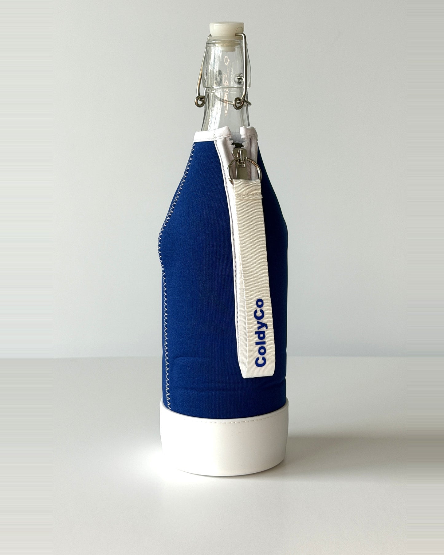 ColdyCo Blue and White bottle carrier holding a swing-top glass bottle, side view
