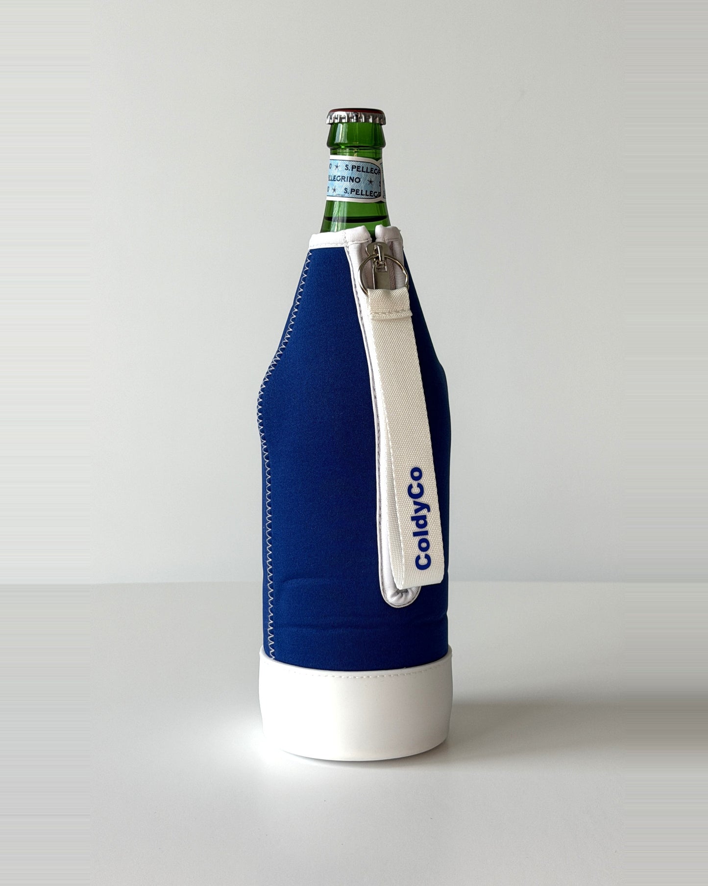 ColdyCo Blue and White neoprene sleeve with wrist strap on a 1-liter glass bottle