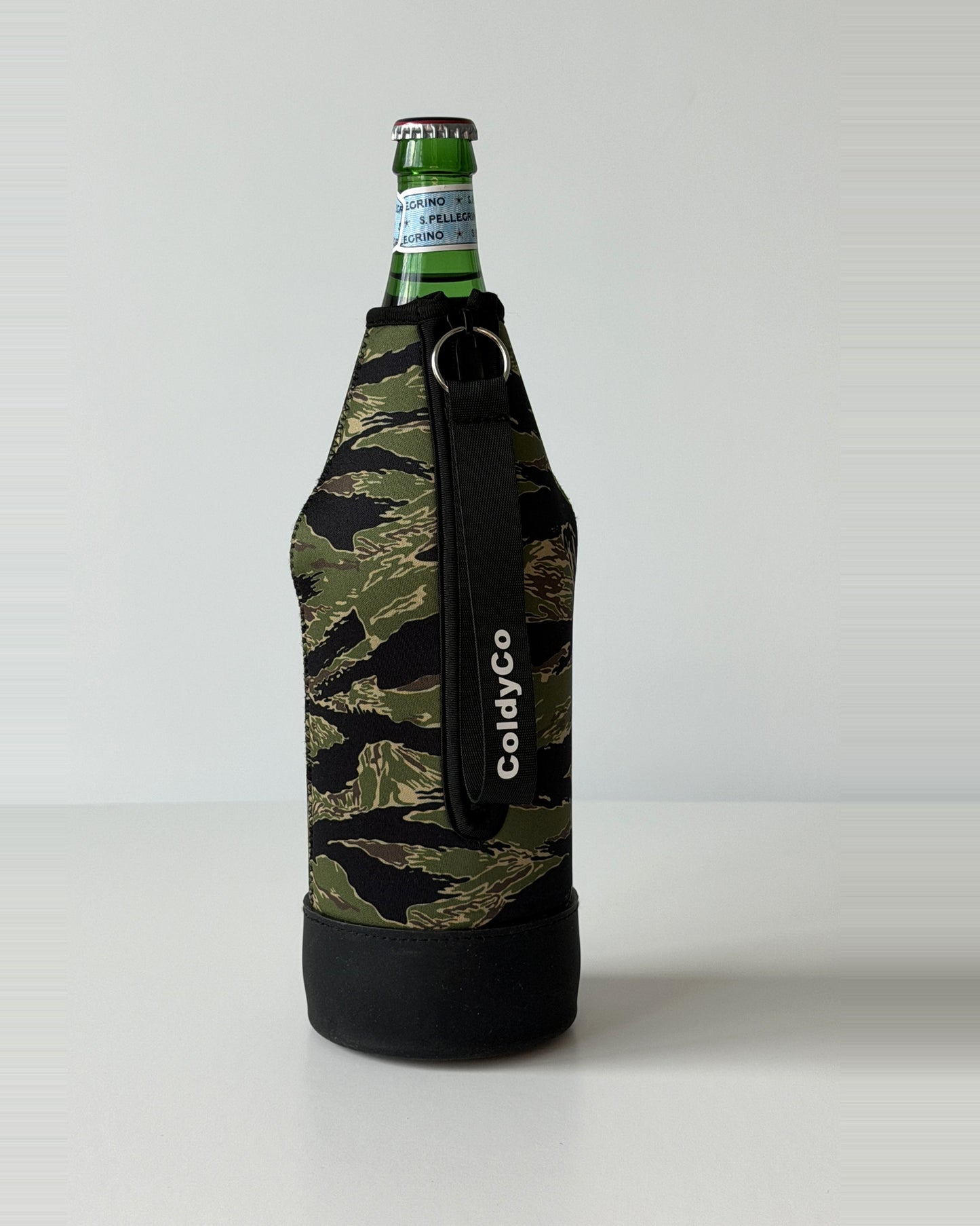 ColdyCo Camo neoprene sleeve with wrist strap on a 1-liter glass bottle