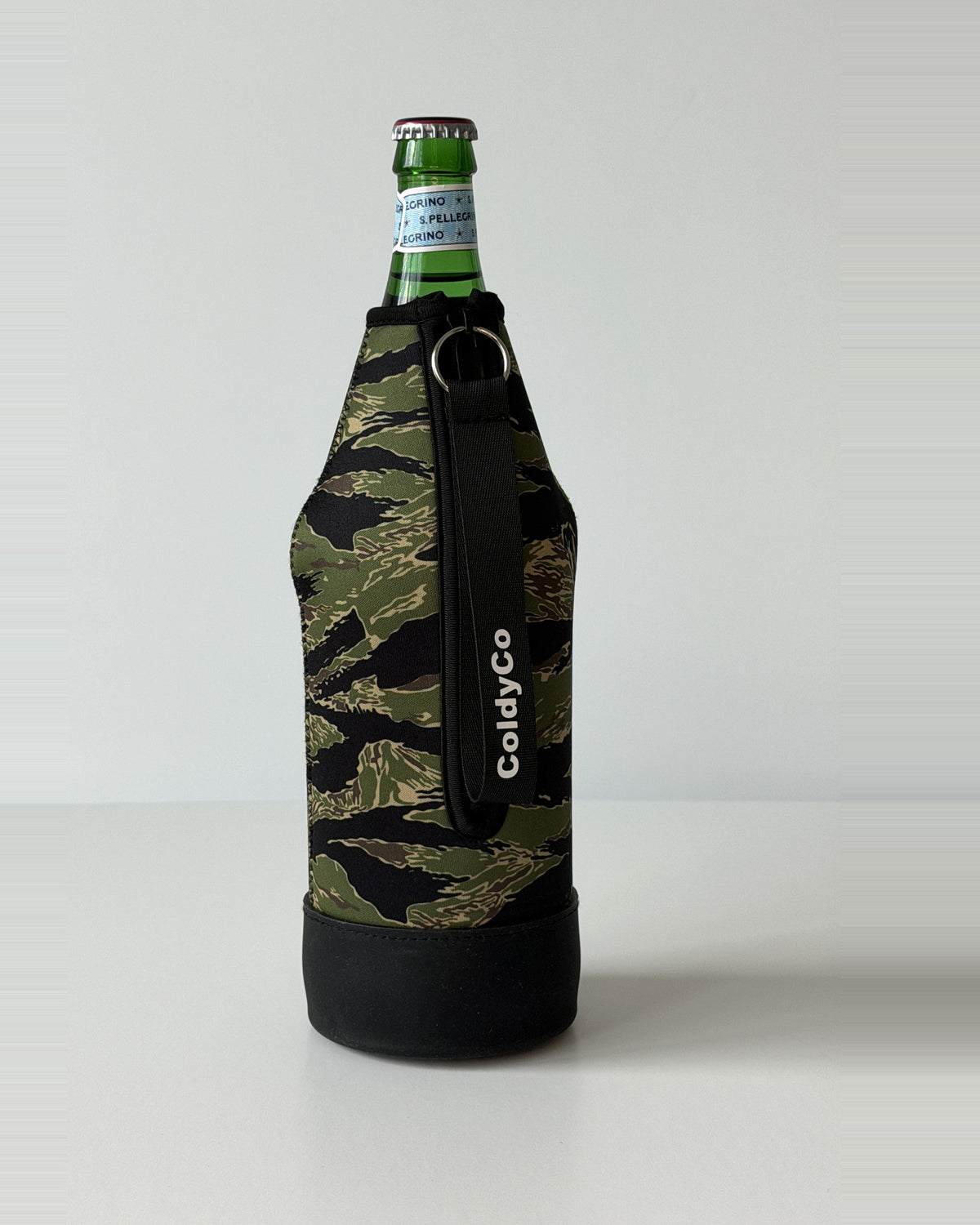 ColdyCo Camo neoprene sleeve with wrist strap on a 1-liter glass bottle