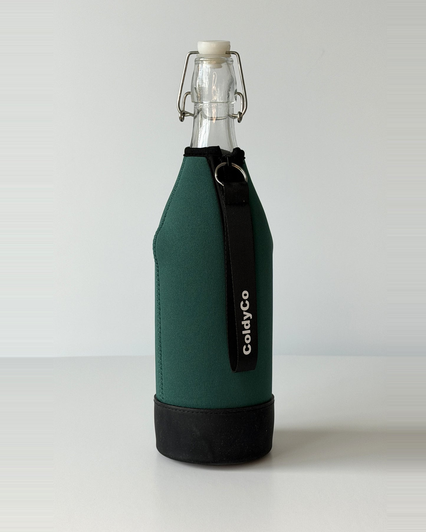 ColdyCo Forest Green bottle carrier holding a swing-top glass bottle, side view
