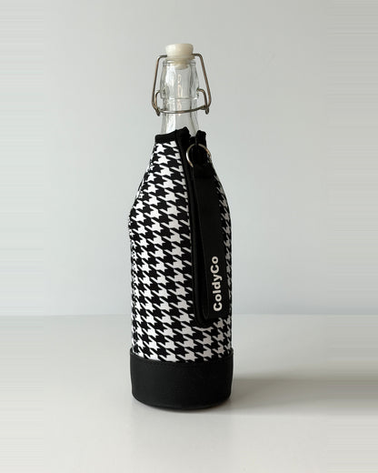 ColdyCo Houndstooth bottle carrier holding a swing-top glass bottle, side view