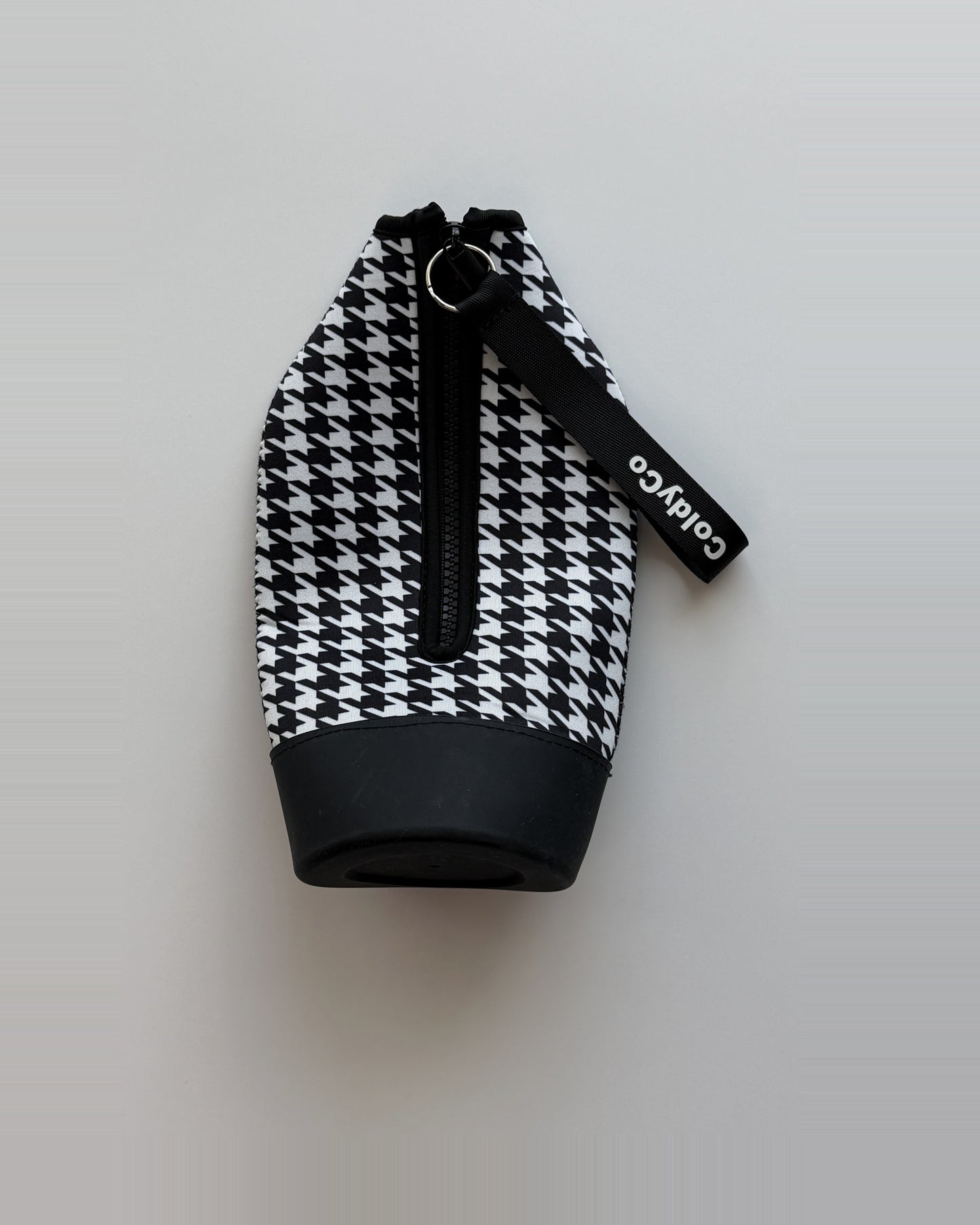 ColdyCo Houndstooth carrier laid flat, showing the full-length zip and rubber base