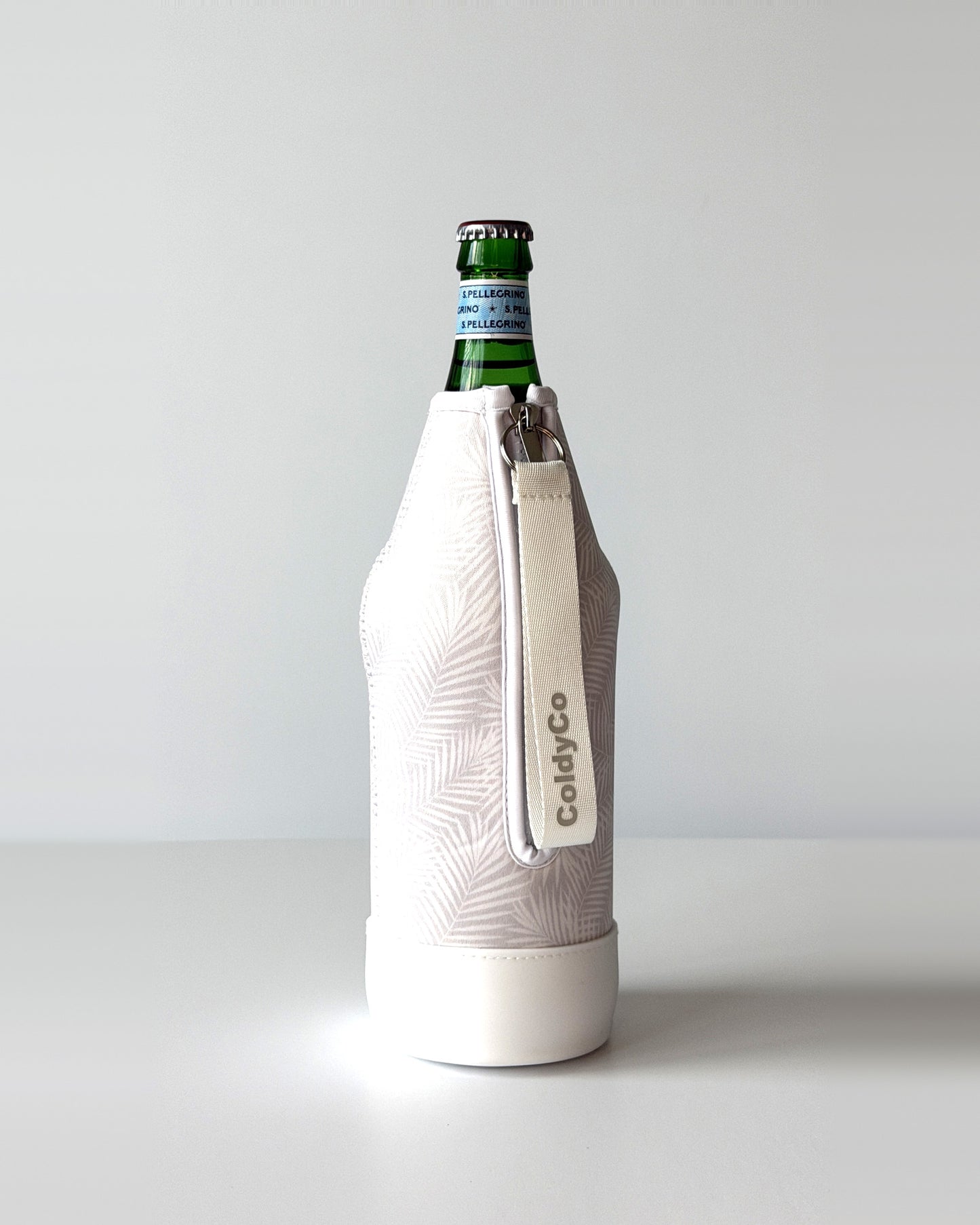 ColdyCo Palm Print neoprene sleeve with wrist strap on a 1-liter glass bottle