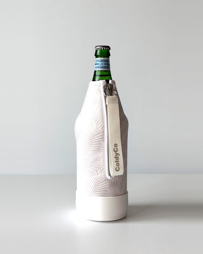 ColdyCo Palm Print neoprene sleeve with wrist strap on a 1-liter glass bottle