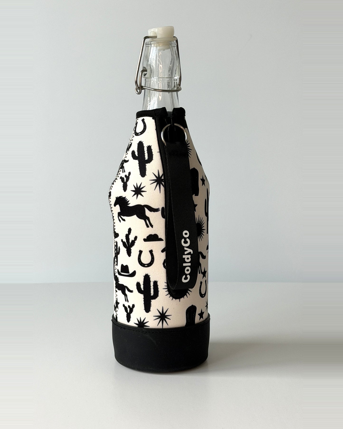 ColdyCo Western Print bottle carrier holding a swing-top glass bottle, side view