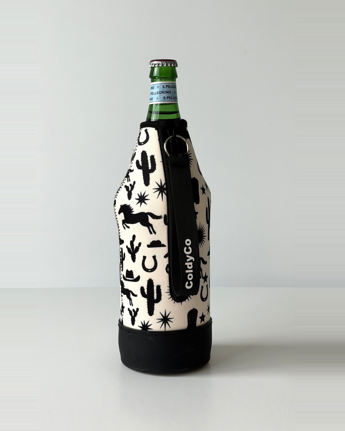 ColdyCo Western Print neoprene sleeve with wrist strap on a 1-liter glass bottle